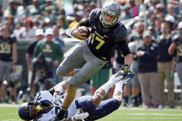 WACO, TX - OCTOBER 17:  Seth Russell #17 of the Baylor Bears carries the ball against Jarrod Harper #22 of the West Virginia Mountaineers in the third quarter at McLane Stadium on October 17, 2015 in Waco, Texas.  (Photo by Tom Pennington/Getty Images)