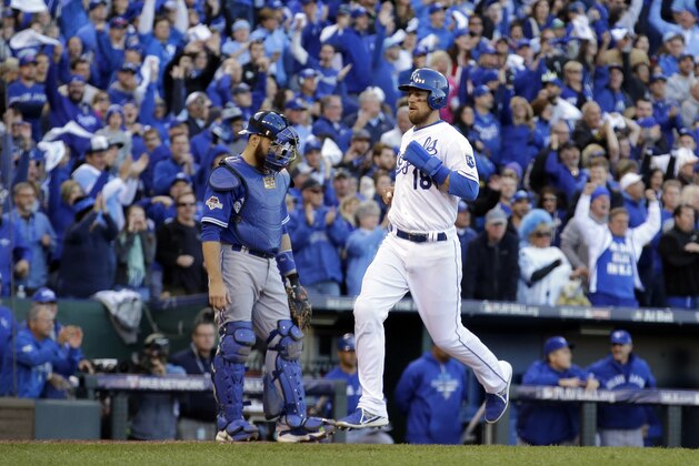 Kansas City Royals' Ben Zobrist, right, scores past Toronto Blue Jays catcher Russell Martin on a single by Eric Hosmer during the seventh inning in Game 2 of baseball's American League Championship Series on Saturday, Oct. 17, 2015, in Kansas City, Mo. (AP Photo/Charlie Riedel)