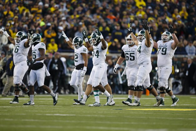 Oct 17, 2015; Ann Arbor, MI, USA; Michigan State Spartans celebrate a touchdown in the third quarter against the Michigan Wolverines at Michigan Stadium. Mandatory Credit: Rick Osentoski-USA TODAY Sports