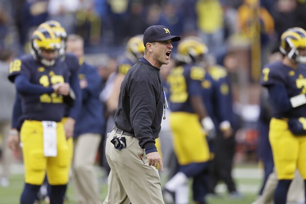 Michigan head coach Jim Harbaugh instructs during pre-game of an NCAA college football game against Michigan State, Saturday, Oct. 17, 2015, in Ann Arbor, Mich. (AP Photo/Carlos Osorio)