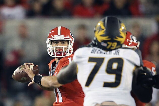 Georgia quarterback Greyson Lambert (11) throws from the pocket as Missouri defensive lineman Terry Beckner Jr. (79) rushes in the first half of an NCAA college football game Saturday, Oct. 17, 2015, in Athens, Ga. (AP Photo/John Bazemore)