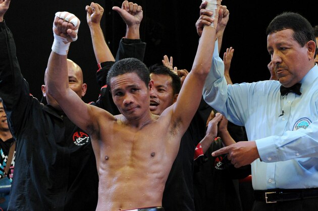 World Boxing Organization light-flyweight champion Donnie Nietes (C) of the Philippines celebrates after defeating Mexican challenger Felipe Salguero on June 2, 2012 during a WBO light-flyweight title bout in Manila, retaining his title.               AFP PHOTO / Jay DIRECTO        (Photo credit should read JAY DIRECTO/AFP/GettyImages)
