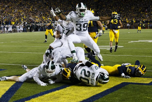 Oct 17, 2015; Ann Arbor, MI, USA; Michigan State Spartans defensive back Jalen Watts-Jackson (20) dives into the end zone for a game winning touchdown as the clock runs out in the fourth quarter against the Michigan Wolverines at Michigan Stadium. Michigan State 27-23. Mandatory Credit: Rick Osentoski-USA TODAY Sports