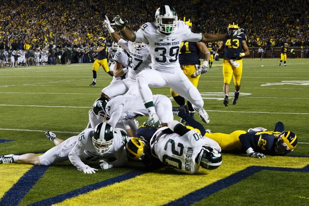 Oct 17, 2015; Ann Arbor, MI, USA; Michigan State Spartans defensive back Jalen Watts-Jackson (20) dives into the end zone for a game winning touchdown as the clock runs out in the fourth quarter against the Michigan Wolverines at Michigan Stadium. Michigan State 27-23. Mandatory Credit: Rick Osentoski-USA TODAY Sports