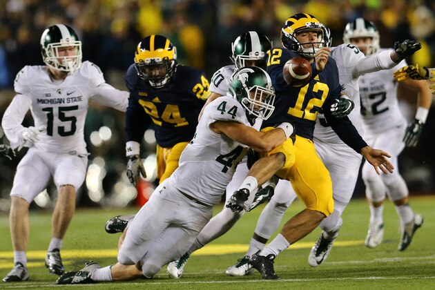 ANN ARBOR, MI - OCTOBER 17:  Alex Malzone #12 of the Michigan Wolverines fumbles late in the fourth quarter at Michigan Stadium on October 17, 2015 in East Lansing, Michigan. (Photo by Rey Del Rio/Getty Images)
