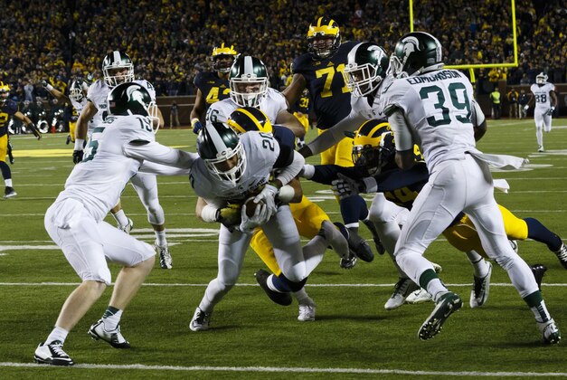 Oct 17, 2015; Ann Arbor, MI, USA; Michigan State Spartans defensive back Jalen Watts-Jackson (20) dives into the end zone for a game winning touchdown as the clock runs out in the fourth quarter against the Michigan Wolverines at Michigan Stadium. Michigan State 27-23. Mandatory Credit: Rick Osentoski-USA TODAY Sports Oct 17, 2015; Ann Arbor, MI, USA; Michigan State Spartans defensive back Jalen Watts-Jackson (20) dives into the end zone for a game winning touchdown as the clock runs out in the fourth quarter against the Michigan Wolverines at Michigan Stadium. Michigan State 27-23. Mandatory Credit: Rick Osentoski-USA TODAY Sports
