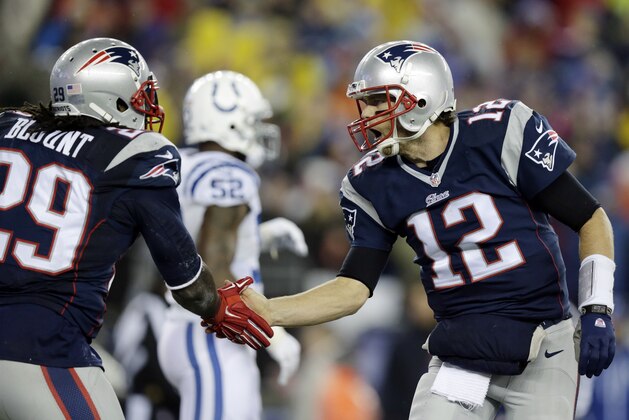 New England Patriots quarterback Tom Brady (12) congratulates LeGarrette Blount after his one-yard touchdown run during the first half of the NFL football AFC Championship game against the Indianapolis Colts Sunday, Jan. 18, 2015, in Foxborough, Mass. (AP Photo/Charles Krupa)
