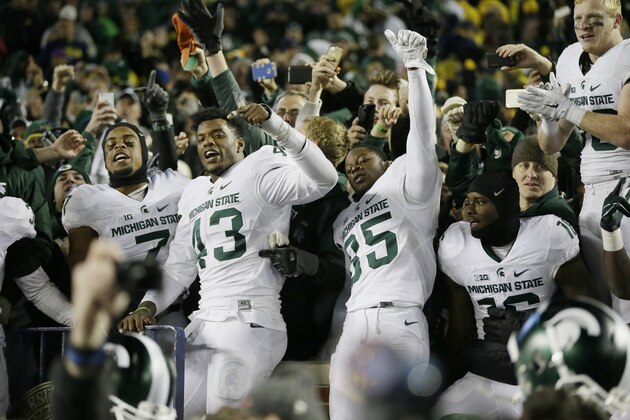 Michigan State players celebrate their 27-23 win over Michigan in an NCAA college football game, Saturday, Oct. 17, 2015, in Ann Arbor, Mich. (AP Photo/Carlos Osorio)