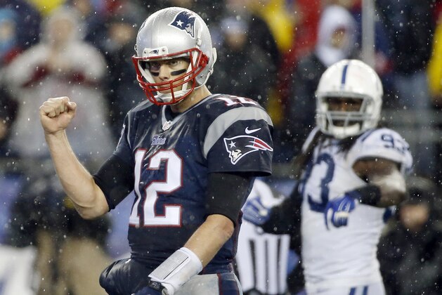 New England Patriots quarterback Tom Brady (12) celebrates LeGarrette Blount's touchdown during the second half of the NFL football AFC Championship game against the Indianapolis Colts Sunday, Jan. 18, 2015, in Foxborough, Mass. (AP Photo/Elise Amendola)