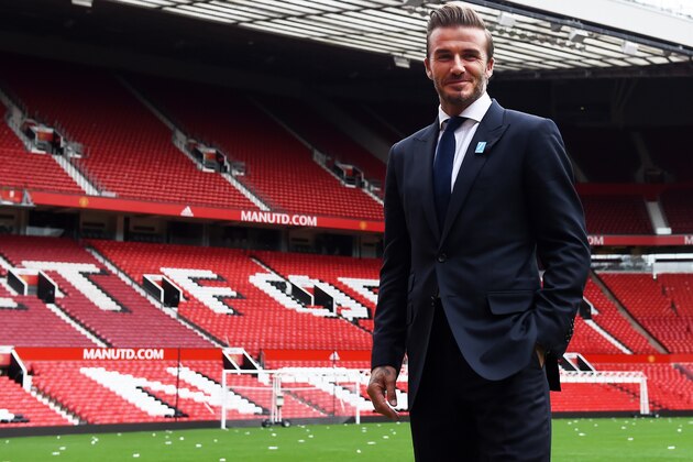Former Manchester United and England footballer David Beckham poses on the pitch at Old Trafford in Manchester, north west England on October 6, 2015 ahead of a charity football match in aid of UNICEF. Beckham will lead the Great Britain and Ireland team against a Rest of the World team led by Zinedine Zidane at Old Trafford on November 14.
 AFP PHOTO/PAUL ELLIS        (Photo credit should read PAUL ELLIS/AFP/Getty Images)