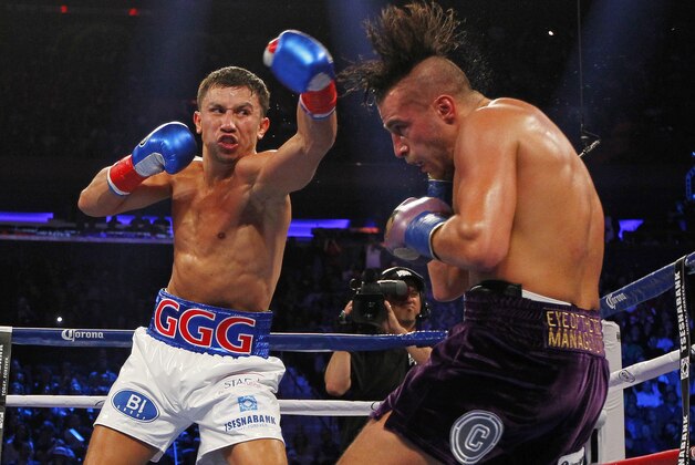 Gennady Golovkin, left, hits David Lemieux in the second round of a middleweight title fight at Madison Square Garden in New York on Saturday, Oct. 17, 2015. Golovkin won in the eighth round. (AP Photo/Rich Schultz)