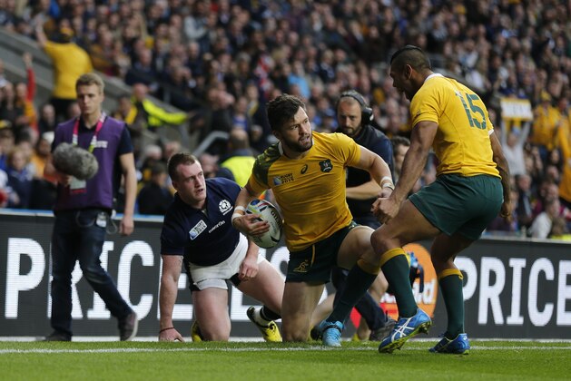 Australia's Adam Ashley-Cooper celebrates scoring a try with teammate Kurtley Beale, right, during the Rugby World Cup quarterfinal match between Australia and Scotland at Twickenham Stadium, London, Sunday, Oct. 18, 2015. (AP Photo/Frank Augstein)