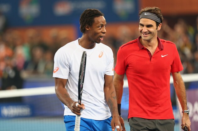 DELHI, INDIA - DECEMBER 08:  Roger Federer of the Indian Aces  with his doubles partner and team mate Gael Monfils during their victory  against  Novak Djokovic and Marin Cilic of the UAE Royals during the Coca-Cola International Premier Tennis League third leg at the Indira Gandhi Indoor Stadium December 8, 2014 in Delhi, Delhi.  (Photo by Clive Brunskill/Getty Images for IPTL 2014)