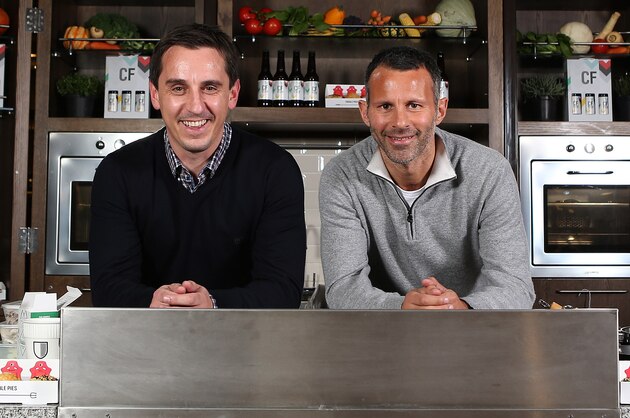 LONDON, ENGLAND - NOVEMBER 20:   Gary Neville and Ryan Giggs pose during a Cook Off at Westfield Stratford City on November 20, 2013 in London, England. Former teammates Gary Neville and Ryan Giggs swapped the pitch for pans when they took part in a cook-off ahead of opening their new restaurant, Cafe Football. (Photo by Jan Kruger/Getty Images)