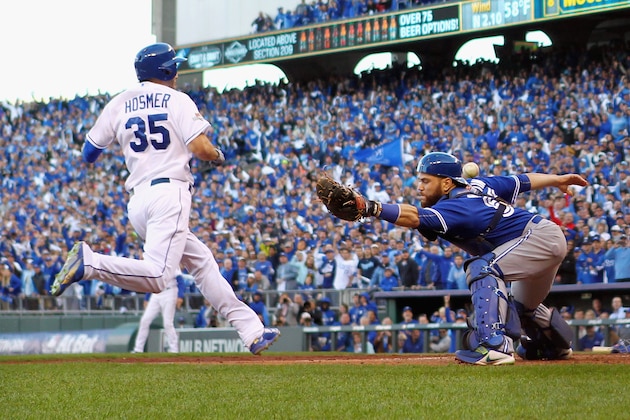 KANSAS CITY, MO - OCTOBER 17:  Eric Hosmer #35 of the Kansas City Royals scores a run as Russell Martin #55 of the Toronto Blue Jays is unable to make the tag in the seventh inning during game two of the American League Championship Series at Kauffman Stadium on October 17, 2015 in Kansas City, Missouri.  (Photo by Jamie Squire/Getty Images)