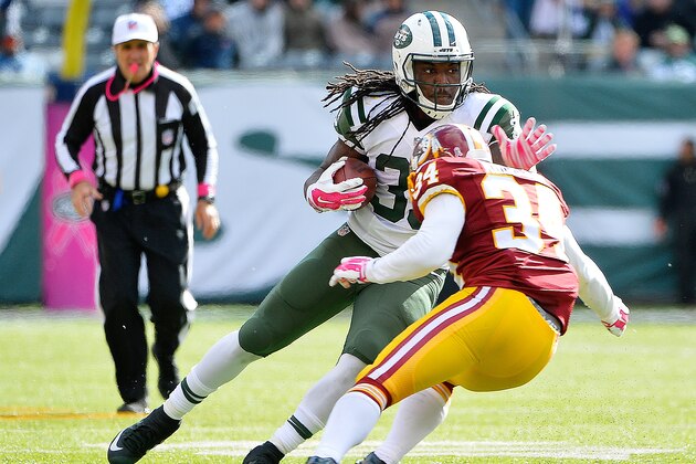 EAST RUTHERFORD, NJ - OCTOBER 18:  Chris Ivory #33 of the New York Jets stiff arms Trenton Robinson #34 of the Washington Redskins to gain extra yards during the third quarter at MetLife Stadium on October 18, 2015 in East Rutherford, New Jersey.  (Photo by Alex Goodlett/Getty Images)
