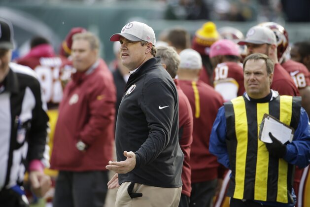 Washington Redskins head coach Jay Gruden, center, looks on during the first half of an NFL football game against the New York Jets, Sunday, Oct. 18, 2015, in East Rutherford, N.J. (AP Photo/Seth Wenig)