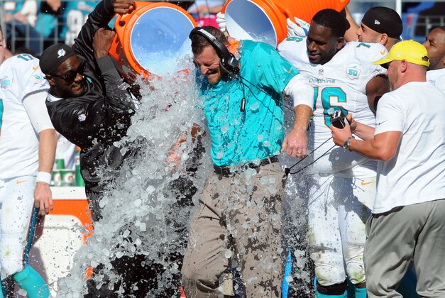 Oct 18, 2015; Nashville, TN, USA; Miami Dolphins interim head coach Dan Campbell is dumped with Gatorade after a win against the Tennessee Titans at Nissan Stadium. The Dolphins won 38-10. Mandatory Credit: Christopher Hanewinckel-USA TODAY Sports