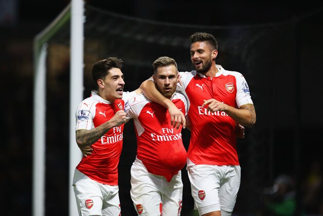 WATFORD, ENGLAND - OCTOBER 17:  Aaron Ramsey of Arsenal (C) celebrates with Hector Bellerin (L) and Olivier Giroud (R) as he scores their third goal during the Barclays Premier League match between Watford and Arsenal at Vicarage Road on October 17, 2015 in Watford, England.  (Photo by Jan Kruger/Getty Images)