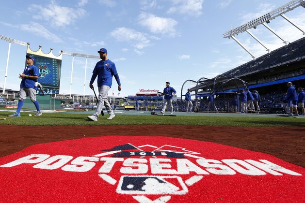 Toronto Blue Jays players walk to the dugout after batting practice before Game 2 of baseball's American League Championship Series against the Kansas City Royals on Saturday, Oct. 17, 2015, in Kansas City, Mo. (AP Photo/Paul Sancya)