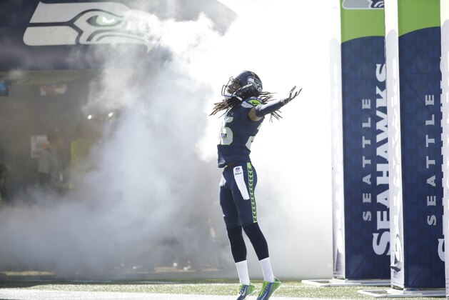 Seattle Seahawks cornerback Richard Sherman (25) runs out of the tunnel for an NFL football game against the Chicago Bears, Sunday, Sept. 27, 2015, in Seattle. (AP Photo/Elaine Thompson)