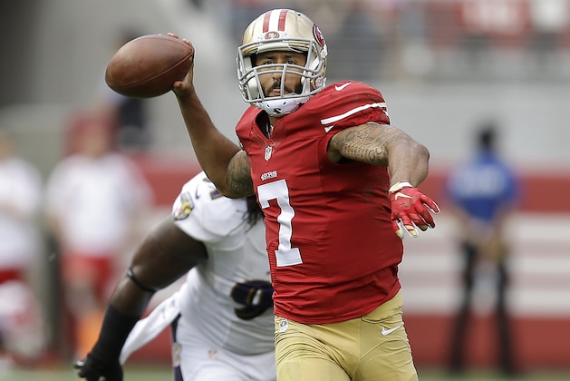 San Francisco 49ers quarterback Colin Kaepernick (7) passes in front of Baltimore Ravens outside linebacker Courtney Upshaw during the first half of an NFL football game in Santa Clara, Calif., Sunday, Oct. 18, 2015. (AP Photo/Ben Margot)