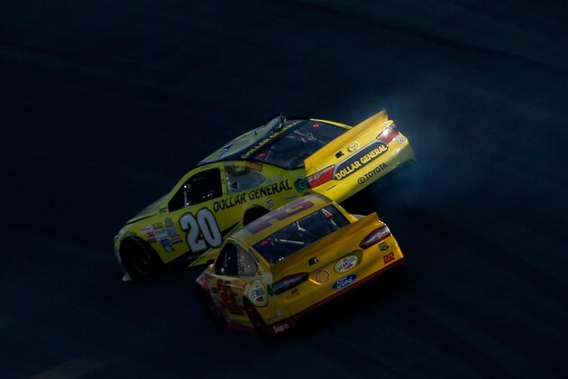 KANSAS CITY, KS - OCTOBER 18:  Joey Logano, driver of the #22 Shell Pennzoil Ford, makes contact with Matt Kenseth, driver of the #20 Dollar General Toyota, during the NASCAR Sprint Cup Series Hollywood Casino 400 at Kansas Speedway on October 18, 2015 in Kansas City, Kansas.  (Photo by Todd Warshaw/Getty Images)