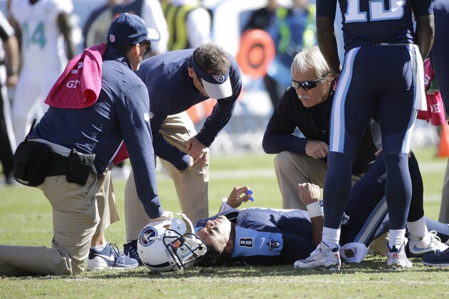 Tennessee Titans quarterback Marcus Mariota (8) is tended to after being injured in the first half of an NFL football game against the Miami Dolphins Sunday, Oct. 18, 2015, in Nashville, Tenn. (AP Photo/James Kenney)