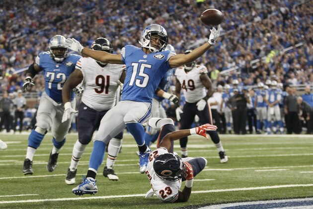 Detroit Lions wide receiver Golden Tate (15) reaches for the ball after Chicago Bears cornerback Kyle Fuller (23) knocked the ball away after Tate crossed the goal line for a touchdown during the first half of an NFL football game, Sunday, Oct. 18, 2015, in Detroit. (AP Photo/Duane Burleson)