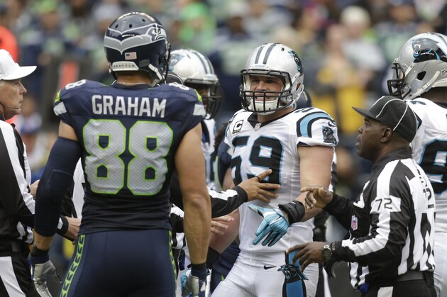 Carolina Panthers middle linebacker Luke Kuechly (59) argues with Seattle Seahawks tight end Jimmy Graham, left, during the first half of an NFL football game, Sunday, Oct. 18, 2015, in Seattle. (AP Photo/Stephen Brashear)