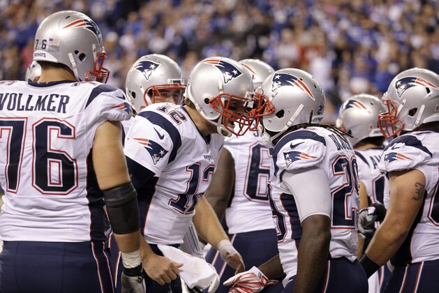 New England Patriots quarterback Tom Brady (12) yells while surrounded by teammates in the second half of an NFL football game against the Indianapolis Colts in Indianapolis, Sunday, Oct. 18, 2015.  (AP Photo/John Minchillo)