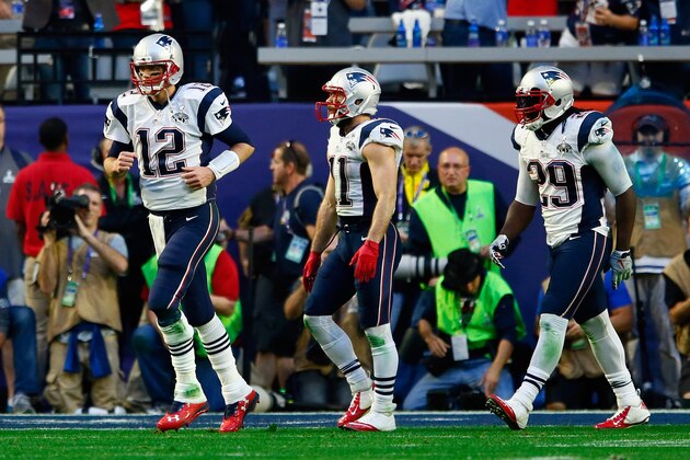 GLENDALE, AZ - FEBRUARY 01:  Tom Brady #12,  Julian Edelman #11 and  LeGarrette Blount #29 of the New England Patriots run back to the sideline after a second quarter touchdown against the Seattle Seahawks during Super Bowl XLIX at University of Phoenix Stadium on February 1, 2015 in Glendale, Arizona.  (Photo by Kevin C. Cox/Getty Images)