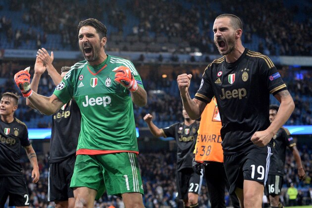 Juventus' goalkeeper from Italy Gianluigi Buffon (L) and Juventus' defender from Italy Leonardo Bonucci (R) celebrate after winning a UEFA Champions League group stage football match between Manchester City and Juventus at the Etihad stadium in Manchester, north-west England on September 15, 2015.  AFP PHOTO / PAUL ELLIS        (Photo credit should read OLI SCARFF/AFP/Getty Images)