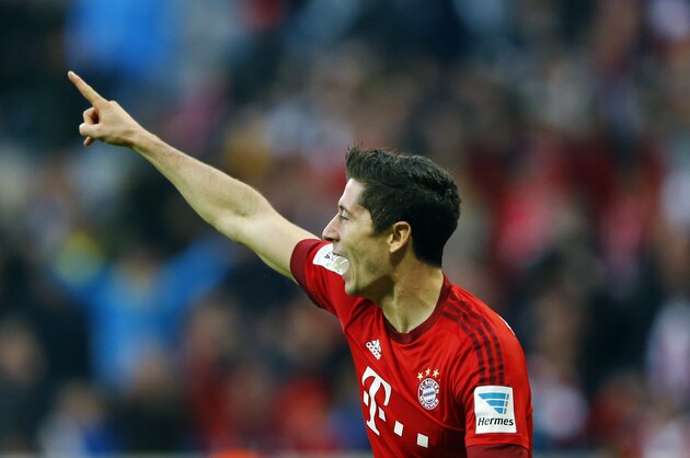 Bayern's Robert Lewandowski celebrates after scoring his side's third goal during the German Bundesliga soccer match between FC Bayern Munich and Borussia Dortmund at the Allianz Arena stadium in Munich, Germany, Sunday, Oct. 4, 2015. (AP Photo/Matthias Schrader)