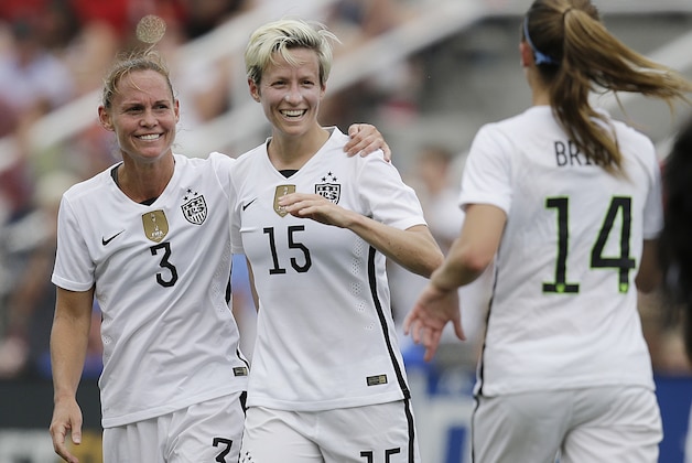 United States' Megan Rapinoe, center and Christie Rampone celebrate a goal in the first half during the US Women's World Cup victory tour, Sunday, Sept. 20, 2015, in Birmingham, Ala. (AP Photo/Brynn Anderson)