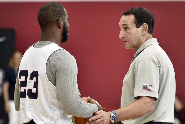 U.S men's basketball coach Mike Krzyzewski, right, speaks with Chris Paul during the team's minicamp Tuesday, Aug. 11, 2015, in Las Vegas. (AP Photo/David Becker)