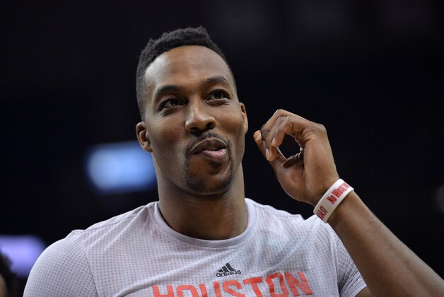 Houston Rockets center Dwight Howard walks off the court after an NBA basketball preseason game against the Memphis Grizzlies Tuesday, Oct. 6, 2015, in Memphis, Tenn. The Grizzlies beat the Rockets 92-89. (AP Photo/Brandon Dill)