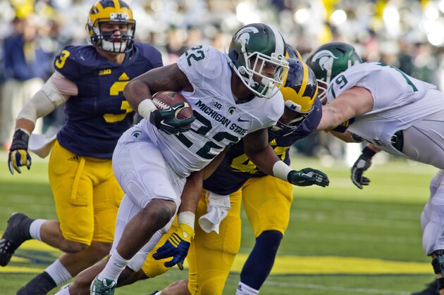 Michigan State running back Delton Williams (22) rushes in the second quarter of an NCAA college football game against Michigan in Ann Arbor, Mich., Saturday, Oct. 17, 2015. (AP Photo/Tony Ding)