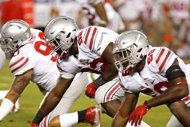 Sep 7, 2015; Blacksburg, VA, USA; Ohio State Buckeyes defensive lineman Tommy Schutt (90), Buckeyes defensive lineman Adolphus Washington (92), and Buckeyes defensive lineman Tyquan Lewis (59) line up against the Virginia Tech Hokies at Lane Stadium. Mandatory Credit: Geoff Burke-USA TODAY Sports