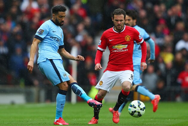 MANCHESTER, ENGLAND - APRIL 12:  Gael Clichy of Manchester City is watched by Juan Mata of Manchester United during the Barclays Premier League match between Manchester United and Manchester City at Old Trafford on April 12, 2015 in Manchester, England.  (Photo by Alex Livesey/Getty Images)