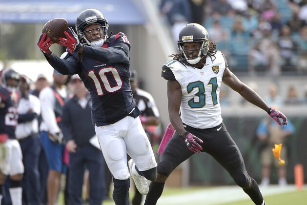 Houston Texans wide receiver DeAndre Hopkins (10) catches a pass in front of Jacksonville Jaguars cornerback Davon House (31) during the second half an NFL football game in Jacksonville, Fla., Sunday, Oct. 18, 2015. The Texans won 31-20. (AP Photo/Phelan M. Ebenhack)