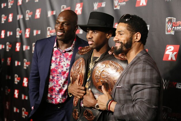 IMAGE DISTRIBUTED FOR 2K - Hip-hop artist Fabolous, center,  holds the championship titles for current WWE Tag Team Champions The Prime Time Players, Titus O’Neil, left, and Darren Young, right, at the WWE 2K SummerSlam Kickoff in New York, N.Y., on Thursday, Aug. 20, 2015. (Photo by Stuart Ramson/Invision for 2K/AP Images)