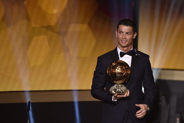 Real Madrid and Portugal forward Cristiano Ronaldo stands on stage after receiving the 2014 FIFA Ballon d'Or award for player of the year during the FIFA Ballon d'Or award ceremony at the Kongresshaus in Zurich on January 12, 2015. AFP PHOTO / FABRICE COFFRINI        (Photo credit should read FABRICE COFFRINI/AFP/Getty Images)