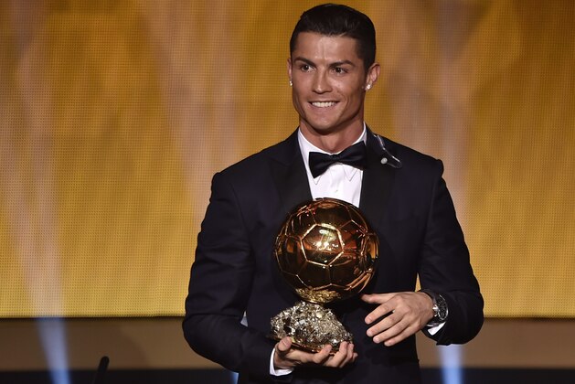 Real Madrid and Portugal forward Cristiano Ronaldo smiles after receiving the 2014 FIFA Ballon d'Or award for player of the year during the FIFA Ballon d'Or award ceremony at the Kongresshaus in Zurich on January 12, 2015. AFP PHOTO / FABRICE COFFRINI        (Photo credit should read FABRICE COFFRINI/AFP/Getty Images)