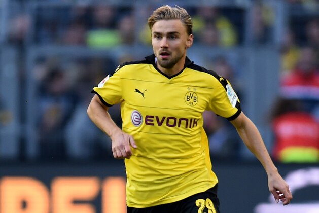 Dortmund's defender Marcel Schmelzer runs with the ball during the German first division Bundesliga football match Borussia Dortmund v SV Darmstadt 98, in Dortmund, western Germany, on September 27, 2015. The match ended with a 2-2 draw. AFP PHOTO / PATRIK STOLLARZ

RESTRICTIONS: DURING MATCH TIME: DFL RULES TO LIMIT THE ONLINE USAGE TO 15 PICTURES PER MATCH AND FORBID IMAGE SEQUENCES TO SIMULATE VIDEO. 
== RESTRICTED TO EDITORIAL USE ==
FOR FURTHER QUERIES PLEASE CONTACT DFL DIRECTLY AT + 49 69 650050.        (Photo credit should read PATRIK STOLLARZ/AFP/Getty Images)