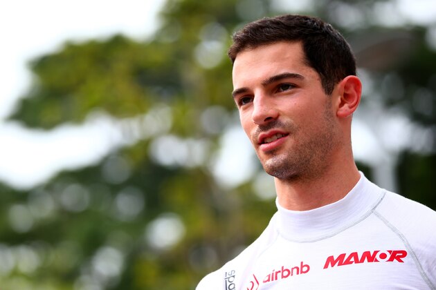 SINGAPORE - SEPTEMBER 17:  Alexander Rossi of the United States and Manor Marussia walks in the paddock during previews to the Formula One Grand Prix of Singapore at Marina Bay Street Circuit on September 17, 2015 in Singapore.  (Photo by Mark Thompson/Getty Images)