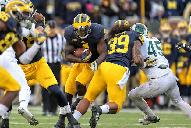 Oct 17, 2015; Ann Arbor, MI, USA; Michigan Wolverines running back De'Veon Smith (4) runs the ball against the Michigan State Spartans during the 2nd half of a game at Michigan Stadium. Mandatory Credit: Mike Carter-USA TODAY Sports