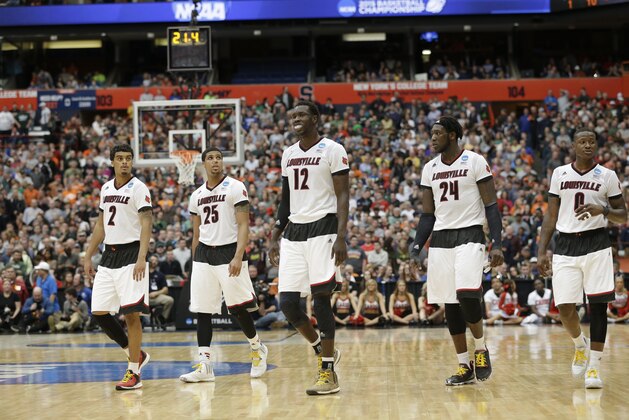 Louisville's Mangok Mathiang (12) takes the court with teammates Quentin Snider (2), Wayne Blackshear (25), Montrezl Harrell (24) and Terry Rozier (0) during the second half of a regional final in the NCAA men's college basketball tournament Sunday, March 29, 2015, in Syracuse, N.Y. (AP Photo/Seth Wenig)