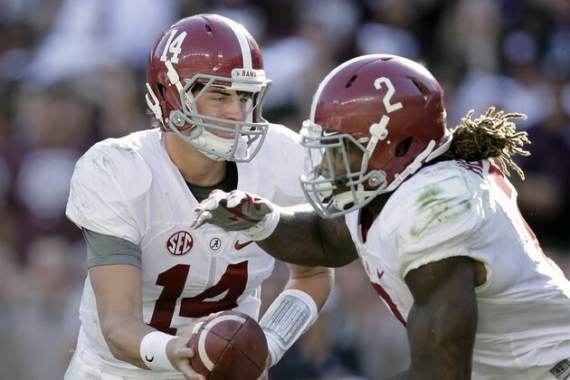 Alabama quarterback Jake Coker (14) hands the ball off to running back Derrick Henry (2) during the first half of an NCAA college football game, Saturday, Oct. 17, 2015, in College Station, Texas. (AP Photo/Eric Gay)