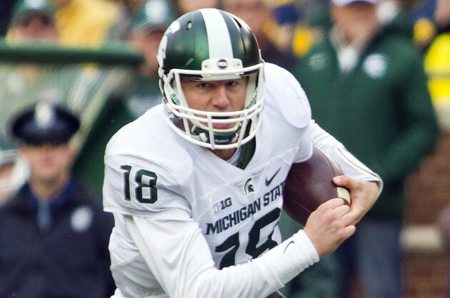 Michigan State quarterback Connor Cook (18) rushes in the second quarter of an NCAA college football game against Michigan in Ann Arbor, Mich., Saturday, Oct. 17, 2015. (AP Photo/Tony Ding)